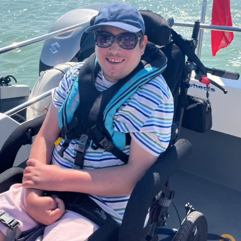 Bob seated securely in his Chunc chair on a speedboat during an outdoor leisure activity