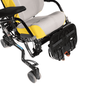 Flip-up footbox accessory on a wheelchair, shown in the raised position